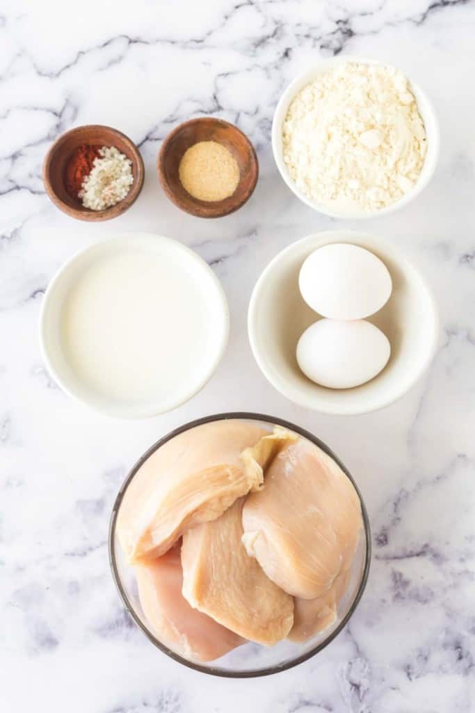 raw ingredients for fried chicken in portioned dishes