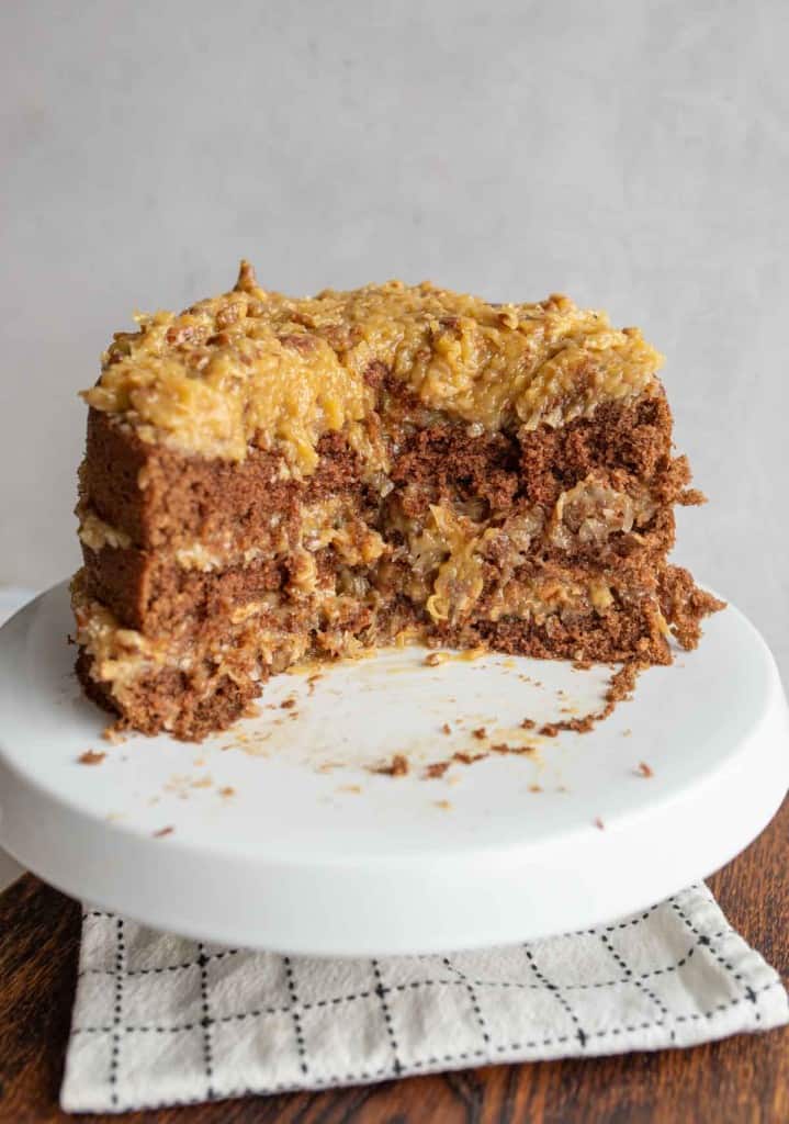 three layered round german chocolate cake with traditional coconut frosting with ⅓ removed