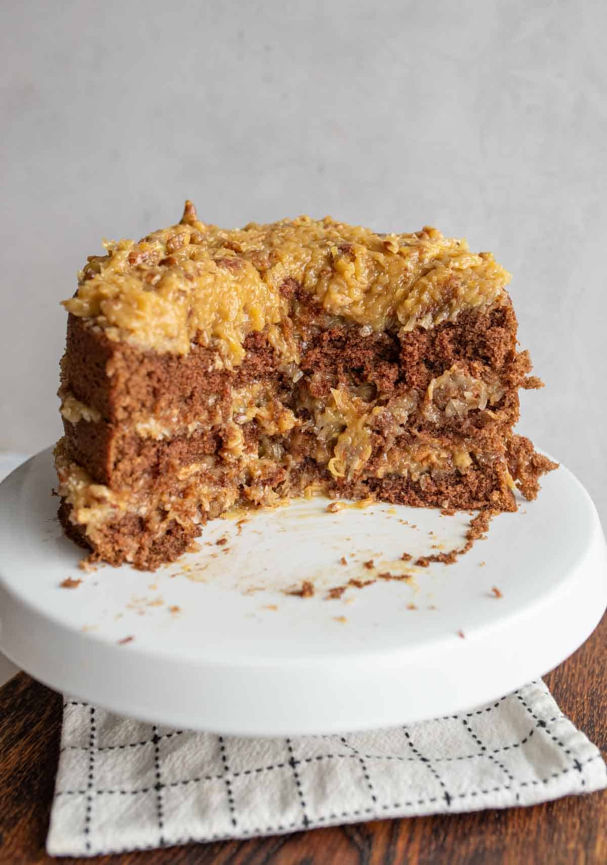 three layered round german chocolate cake with traditional coconut frosting with 1/3 removed