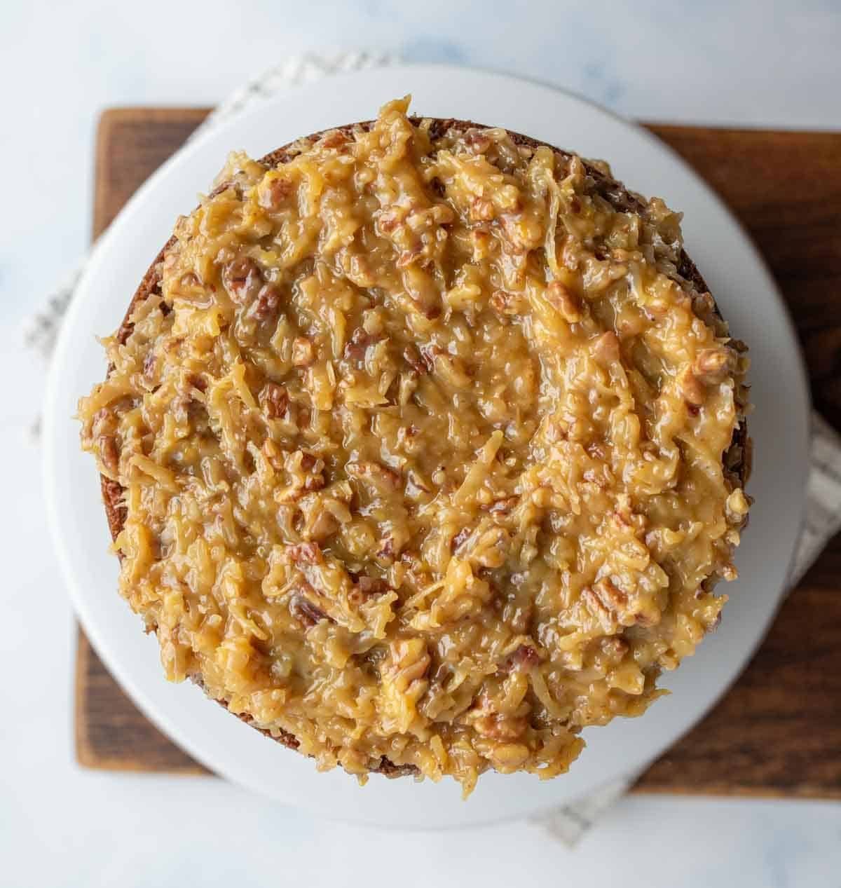 three layered round german chocolate cake with traditional coconut frosting top view whole