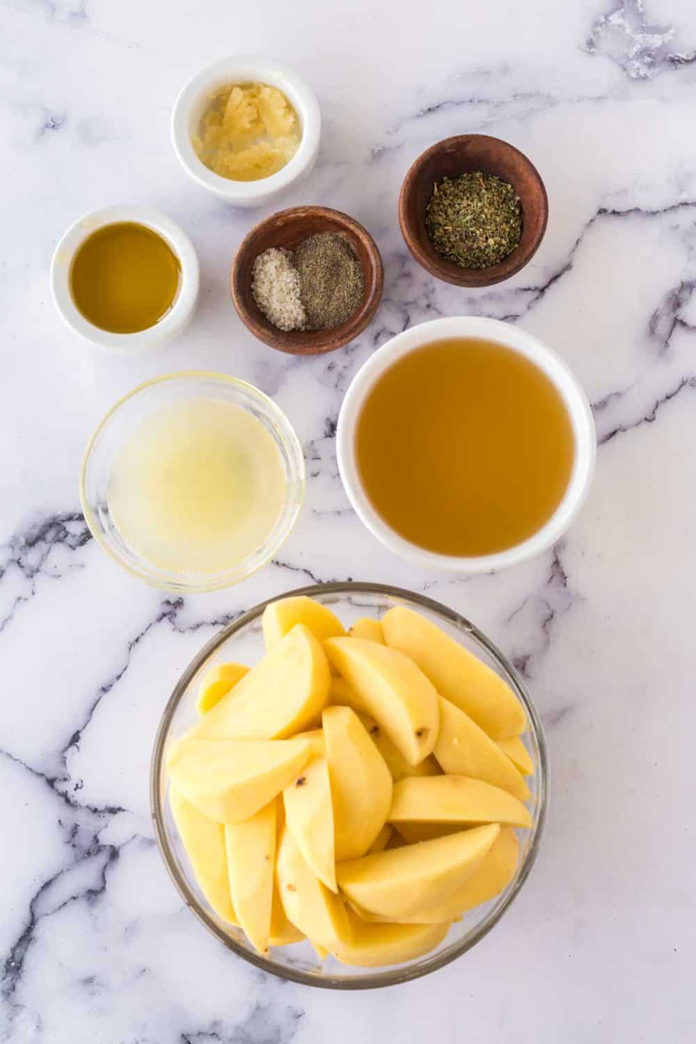 raw ingredients for greek potatos in small portion dishes