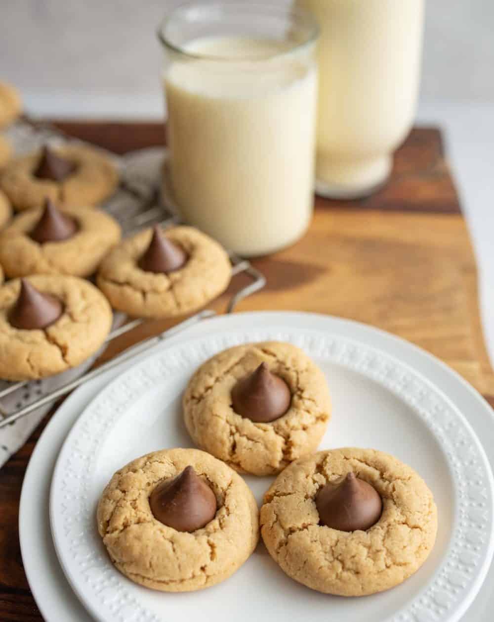 hershey kisses cookies in rows on a baking dish and on a white plate with milk