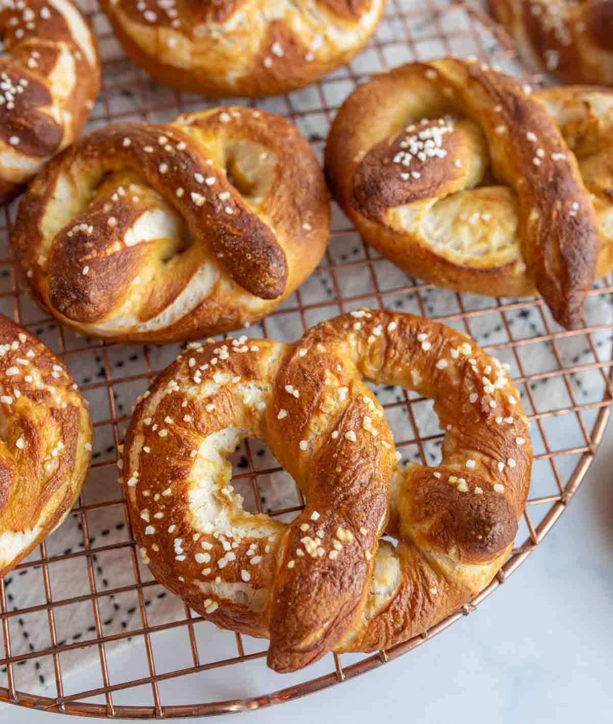 Cooked homemade pretzels on a cooling rack.