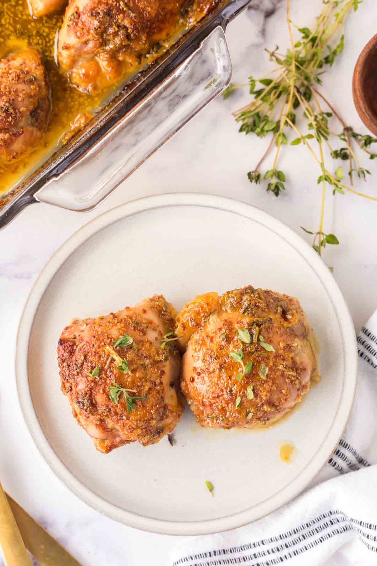 top view of baked and seasoned mustard chicken recipe on a plate