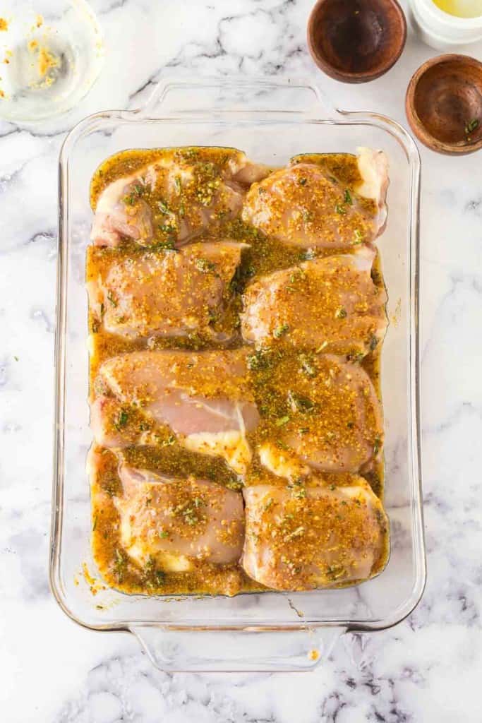 top view of a baking dish of baked and seasoned mustard chicken