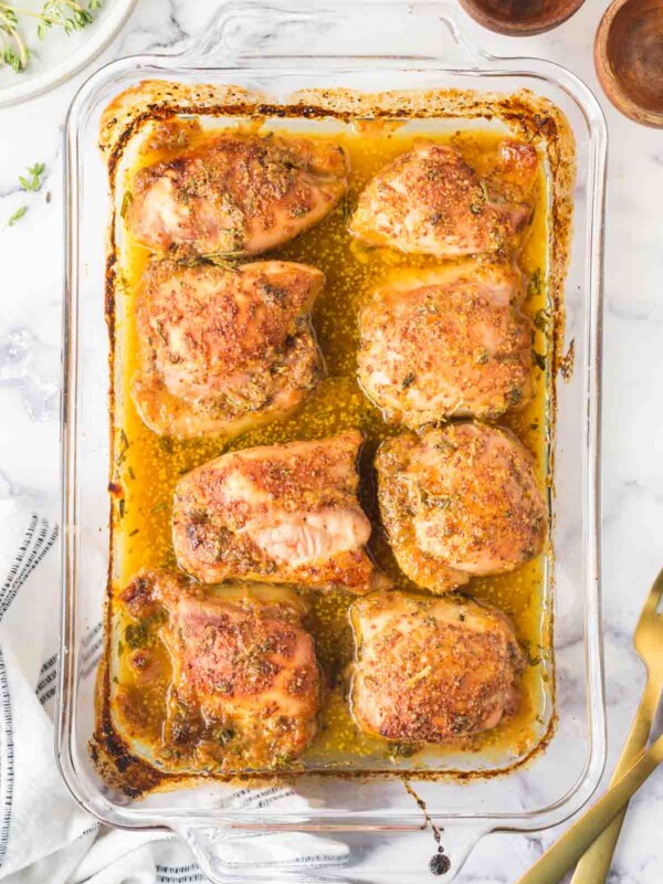 top view of a baking dish of baked and seasoned mustard chicken