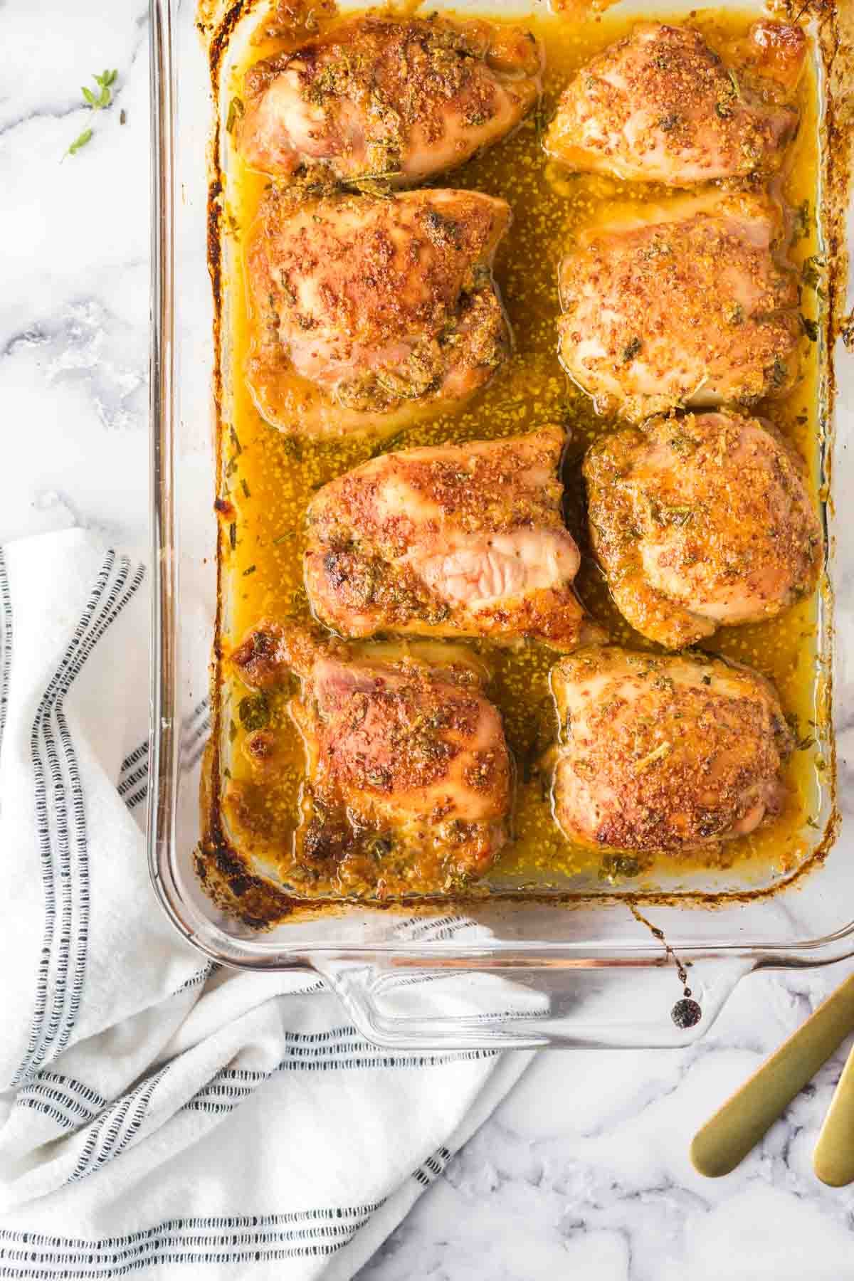 baking dish of baked and seasoned mustard chicken