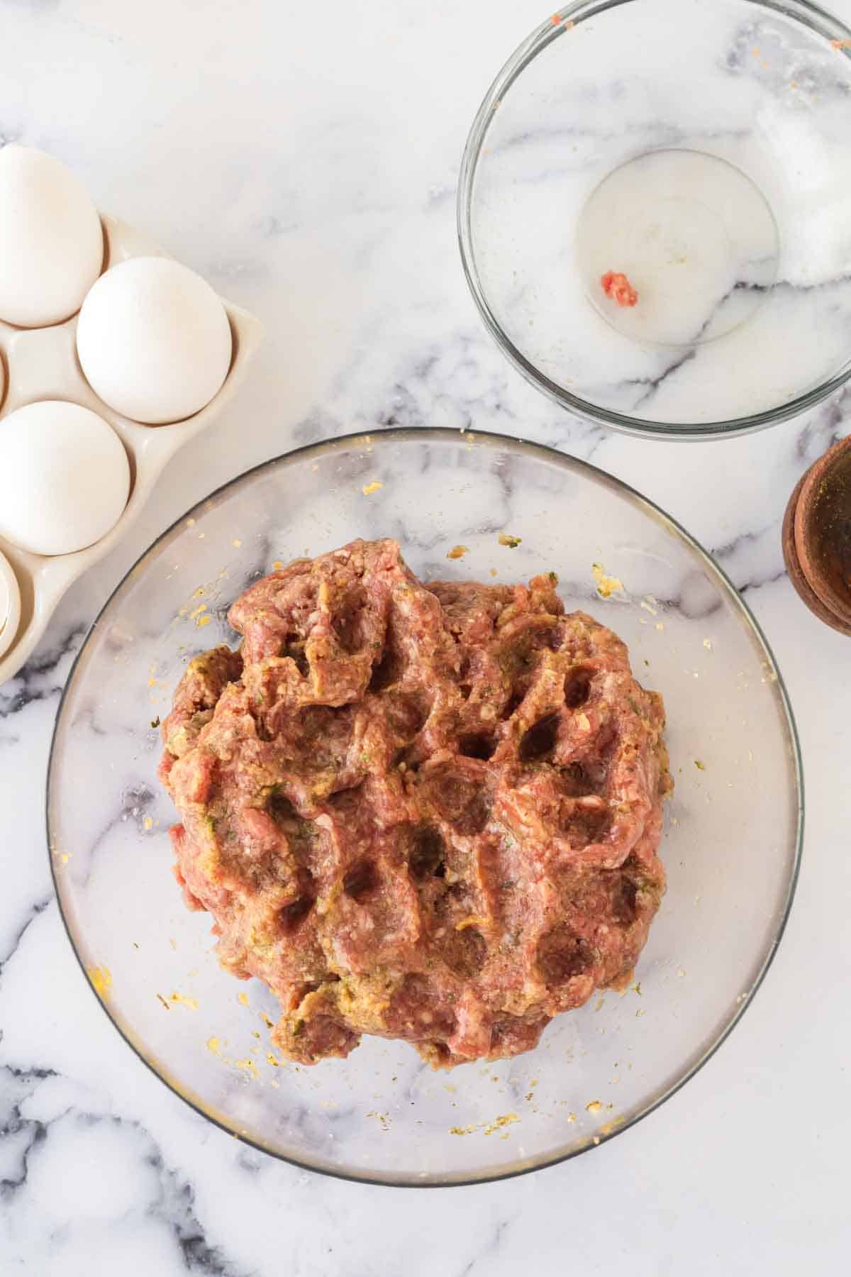 Italian meatball mix in a clear bowl