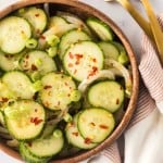 slices of cucumber and spices in a bowl for korean cucumber salad