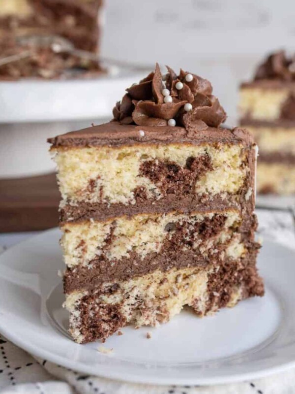 slice of three layered marble cake mixed with vanilla and chocolate cake