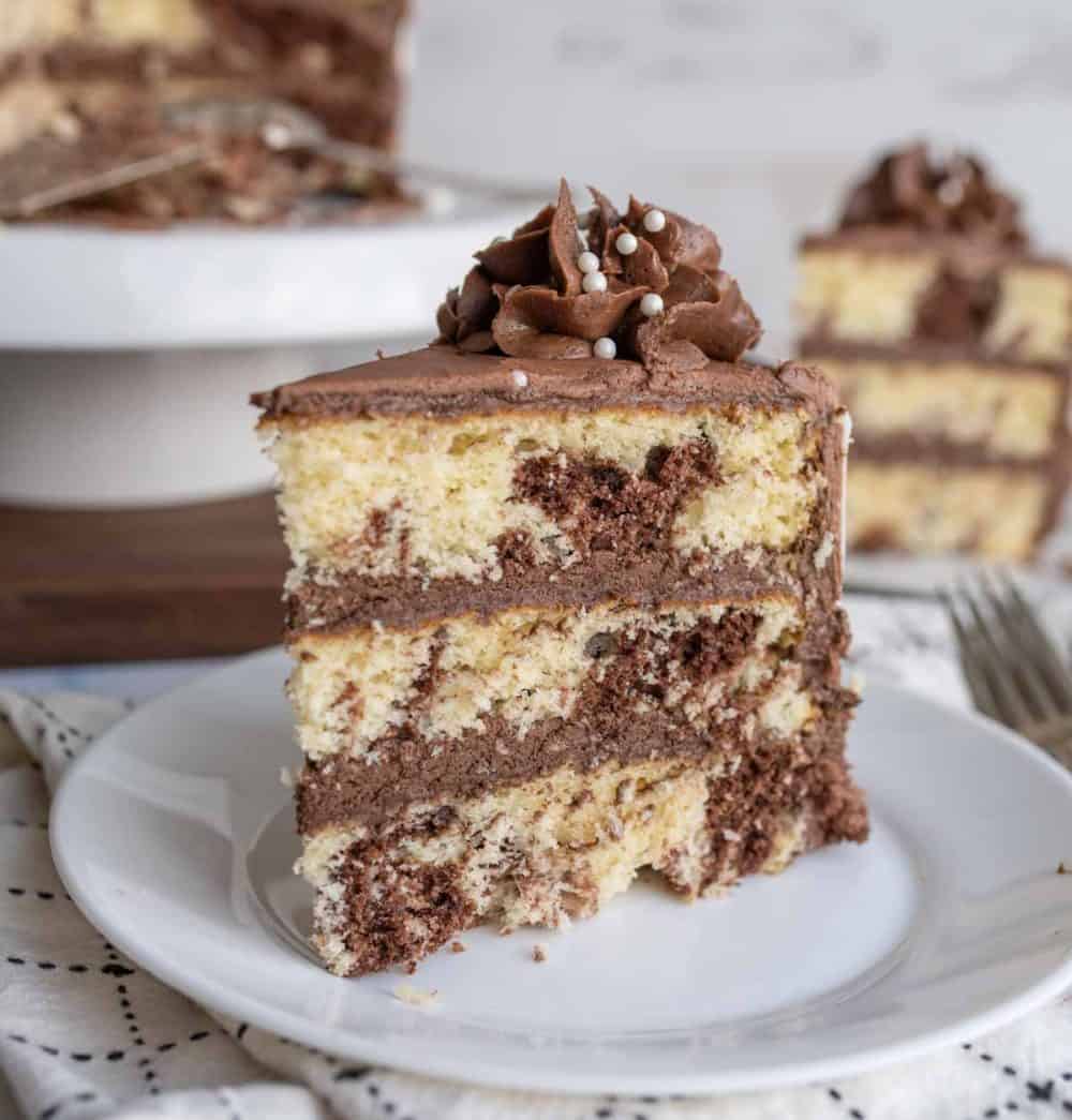 slice of three layered marble cake mixed with vanilla and chocolate cake