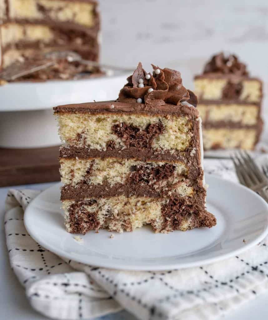 slice of three layered marble cake mixed with vanilla and chocolate cake