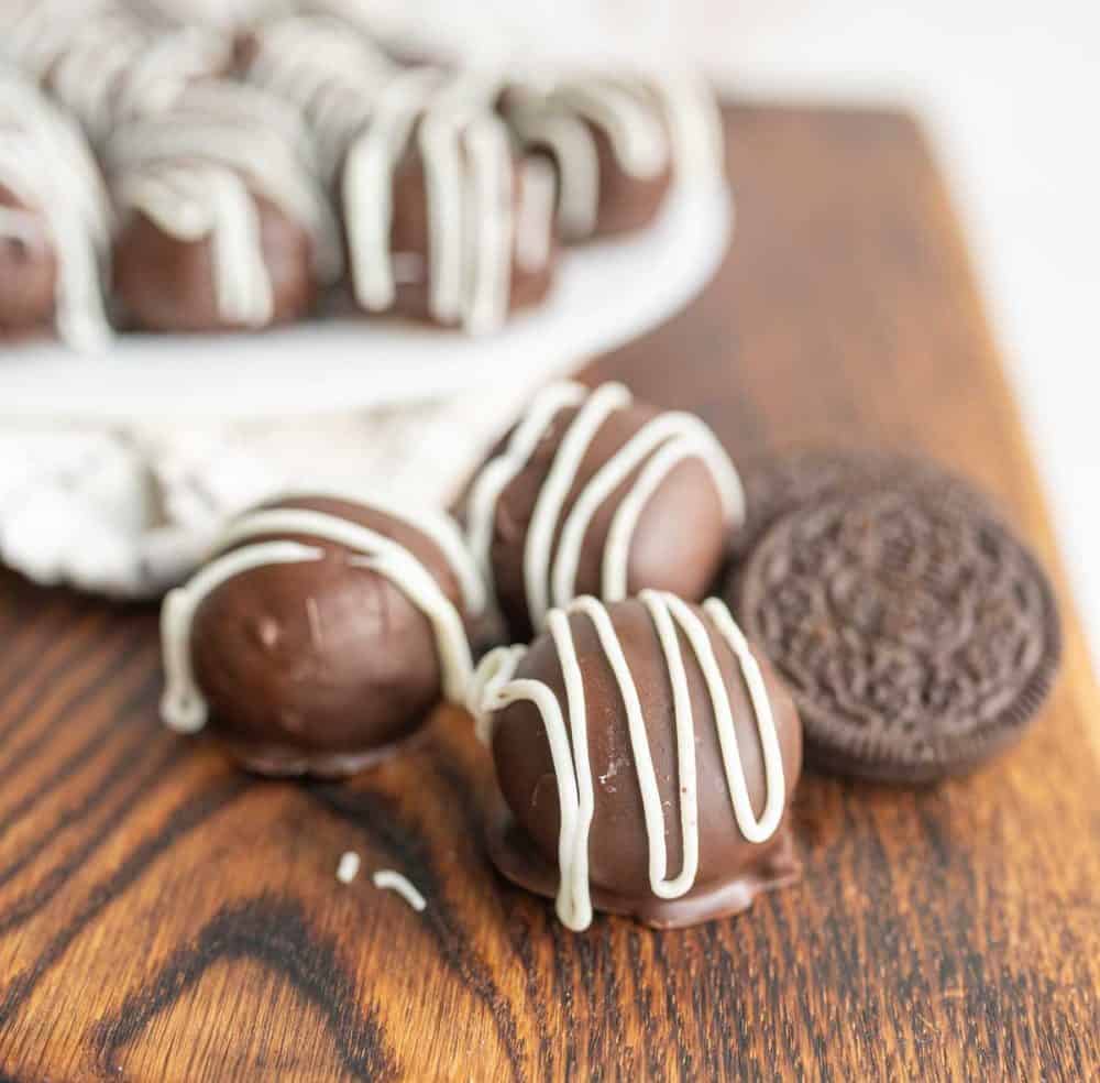 A few oreo balls next to an original oreo cookie.