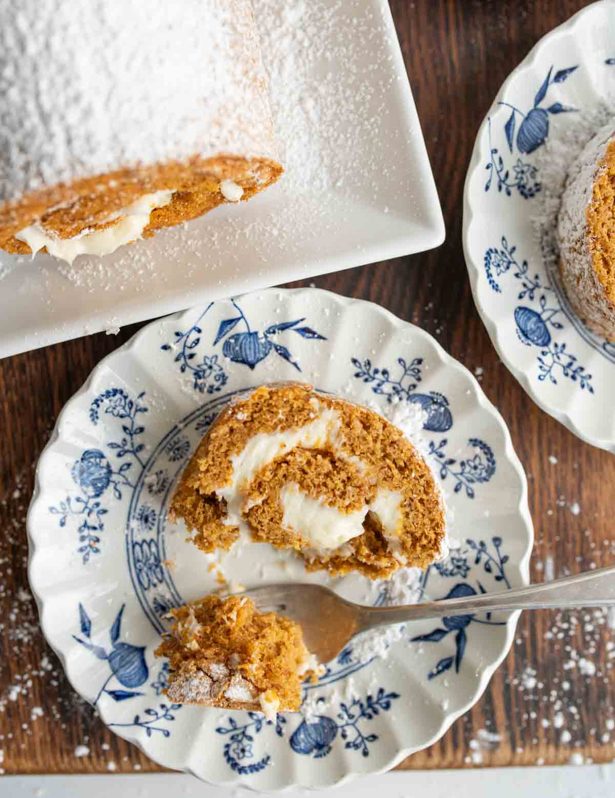 fork biting a piece of a circular pumpkin cake roll