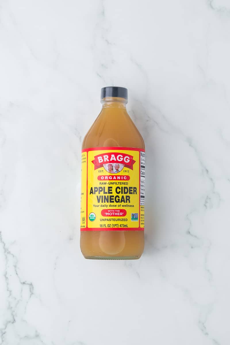 glass bottle of BRAGG organic apple cider vinegar