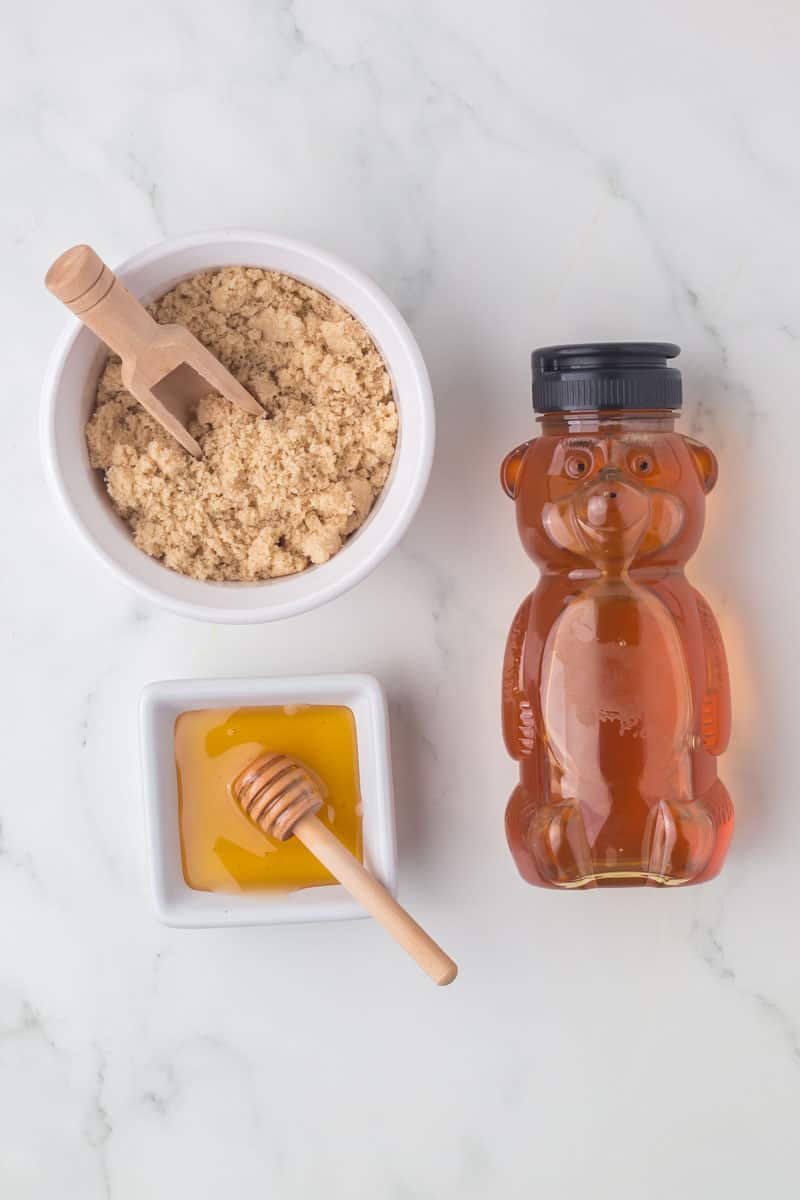 brown sugar substitutes next to a honey bear and a dish of honey