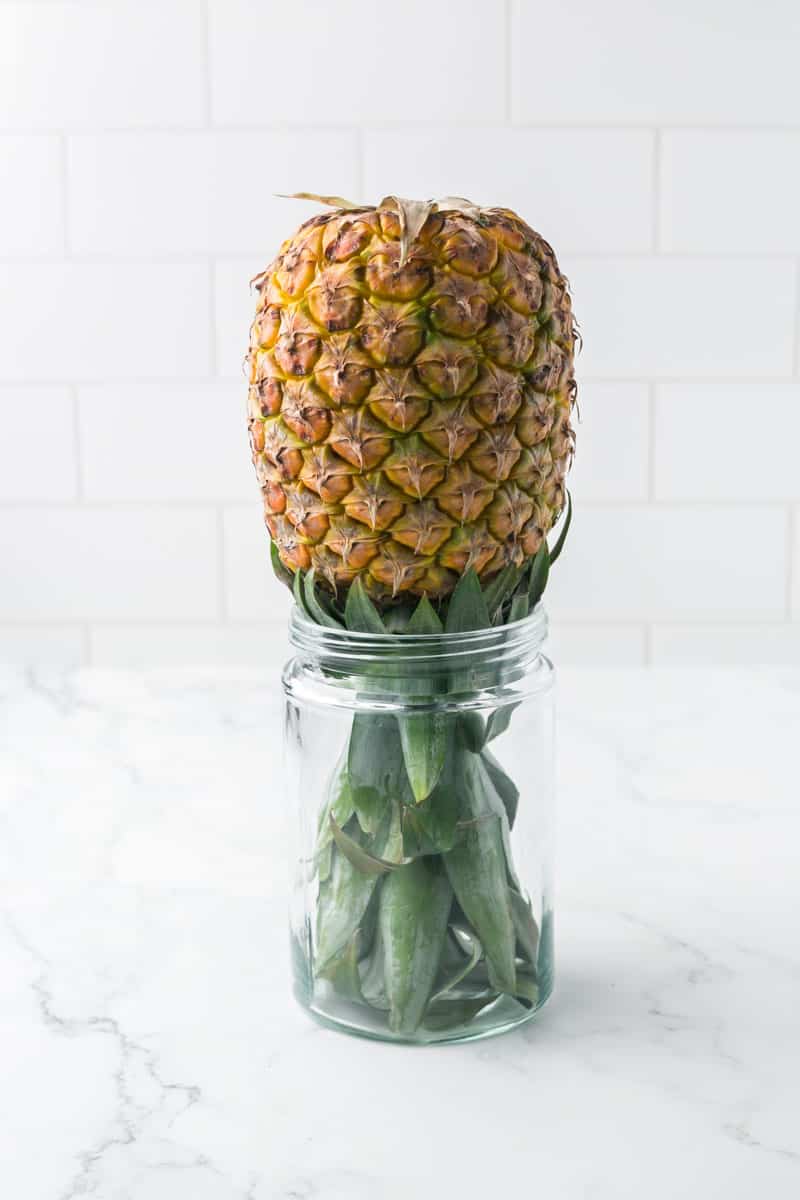 whole fresh pineapple upside down in a mason jar