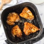 air fryer basket of fried chicken