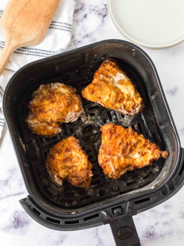 air fryer basket of fried chicken