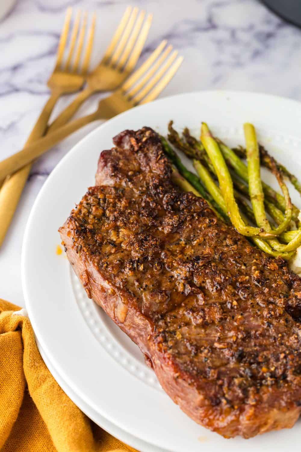 POV air fryer steak with a side of asparagus.