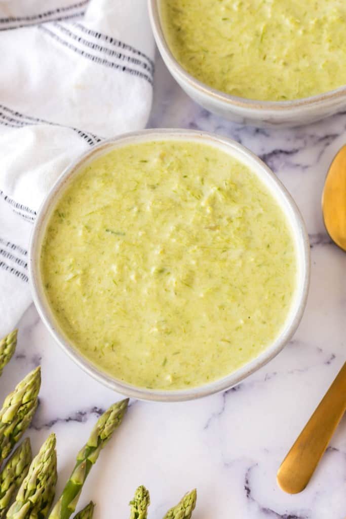 top view aesthetic photo of two bowls of asparagus soup