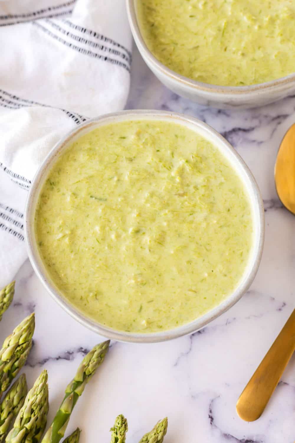 top view aesthetic photo of two bowls of asparagus soup
