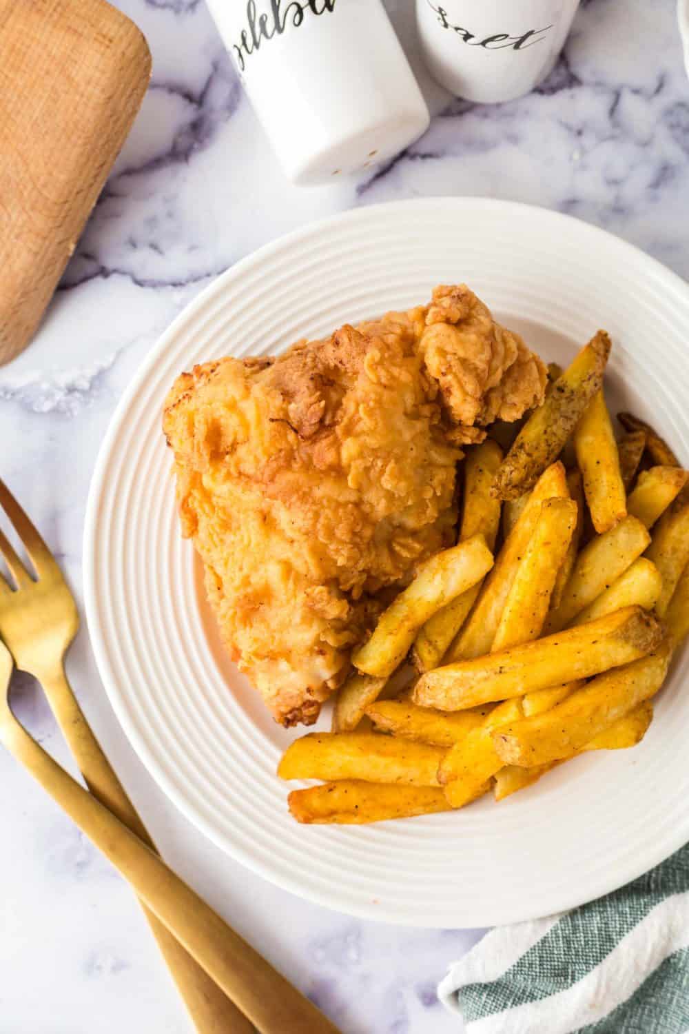 Plate of buttermilk fried chicken and french fries.