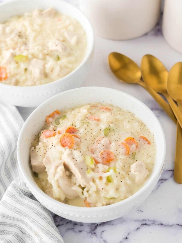 chicken and rice soup in a white serving bowl