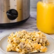 crockpot breakfast casserole with orange juice in the background