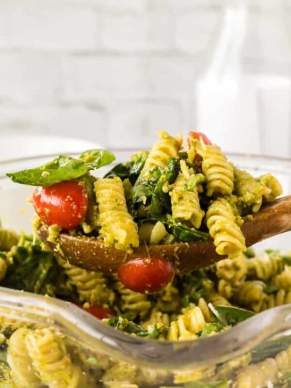 a spoonful of pesto pasta salad with shredded parmesan cheese