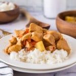 a plate of hawaiian chicken in sauce with pineapples over white rice