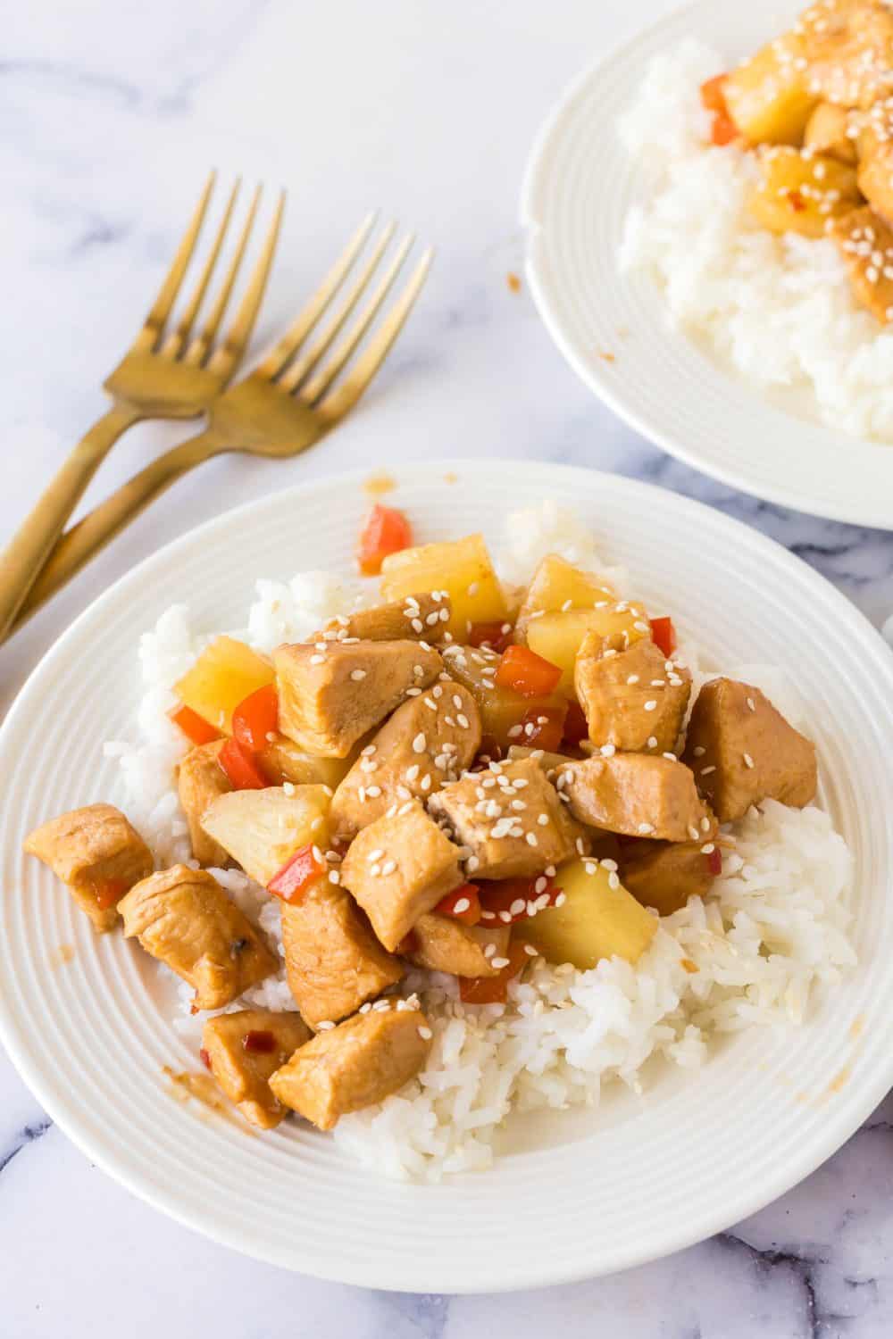 Hawaiian chicken with rice served on a white plate. 