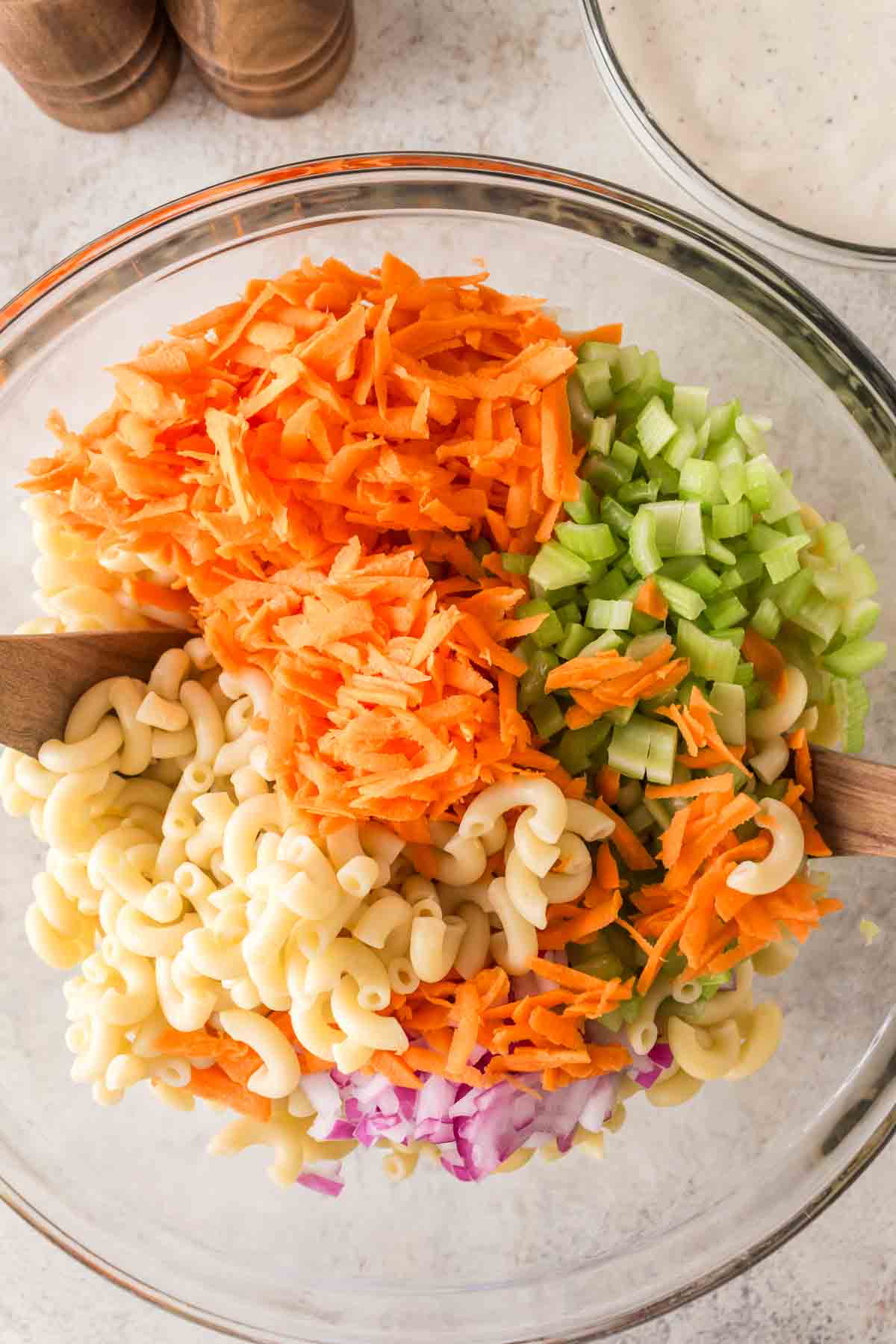 raw ingredients of hawaiian macaroni salad recipe in a clear mixing bowl
