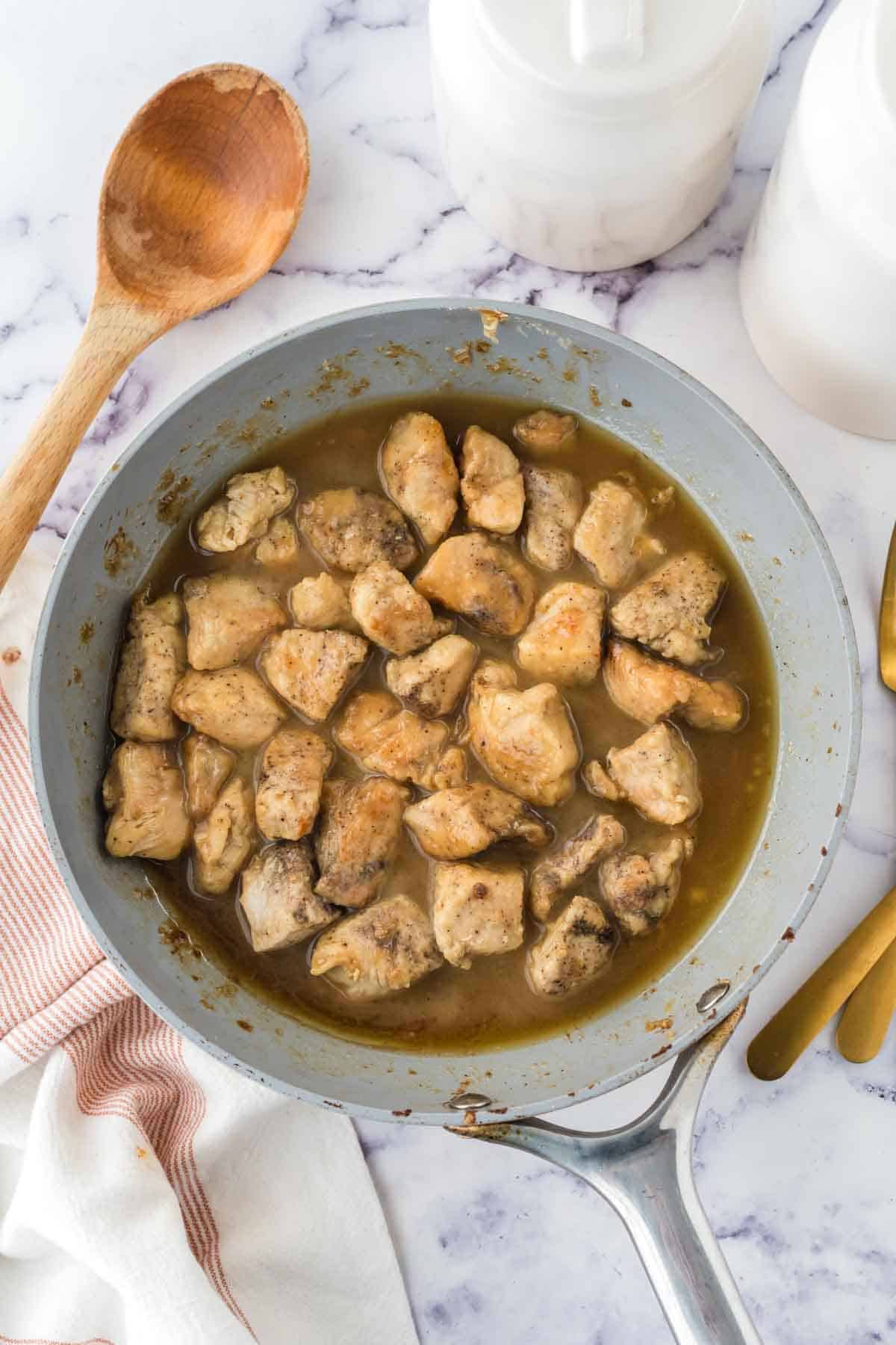 chicken cubes in a saucepan