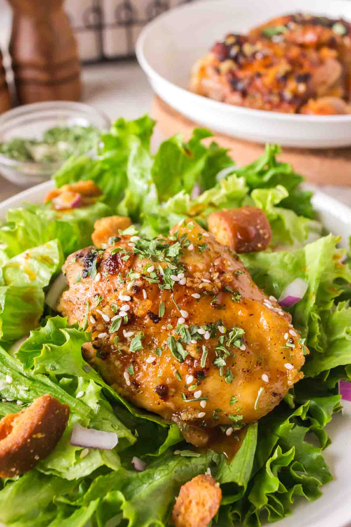 honey garlic chicken thighs over lettuce