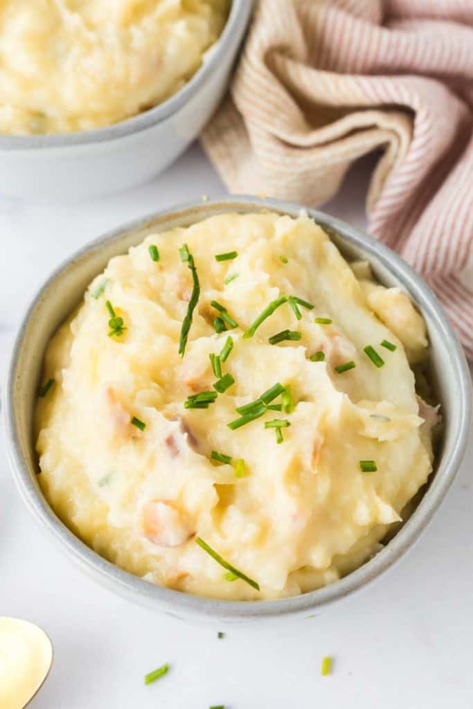 loaded mashed potatoes in a small serving bowl