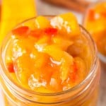 close up of mango chutney in a small mason jar