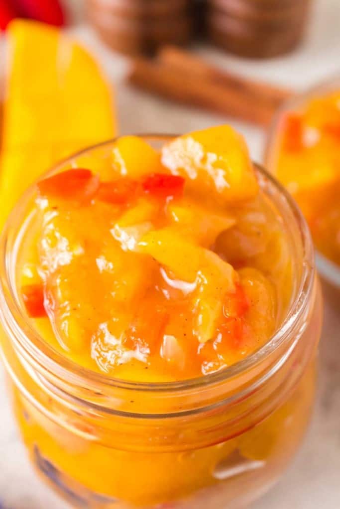 close up of mango chutney in a small mason jar