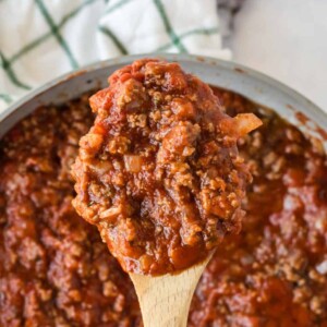 homemade meat sauce on a wooden spoon