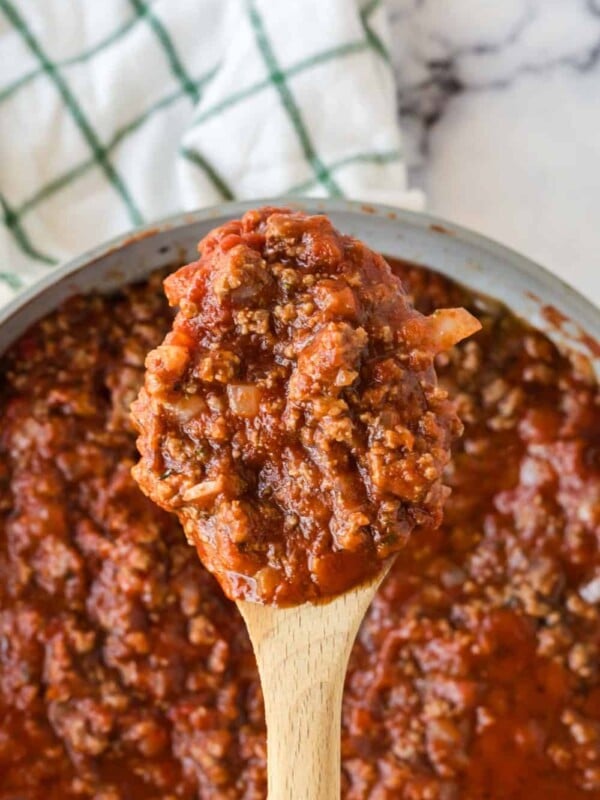 homemade meat sauce on a wooden spoon