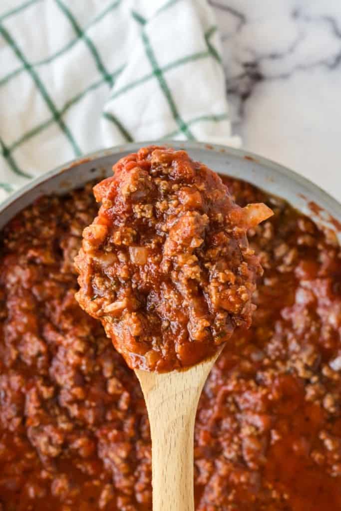 Homemade meat sauce on a wooden spoon.