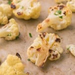 close up of a baking dish with seasoned roasted cauliflower