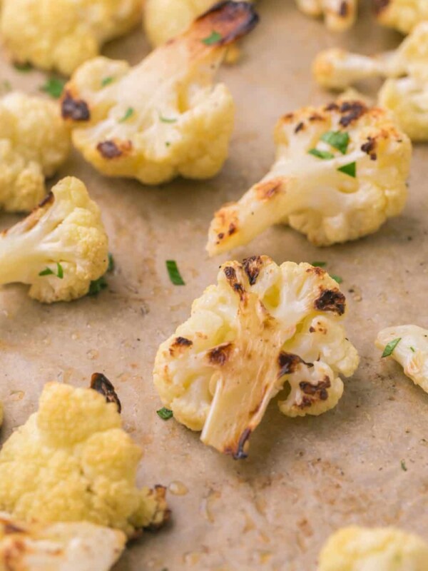 close up of a baking dish with seasoned roasted cauliflower