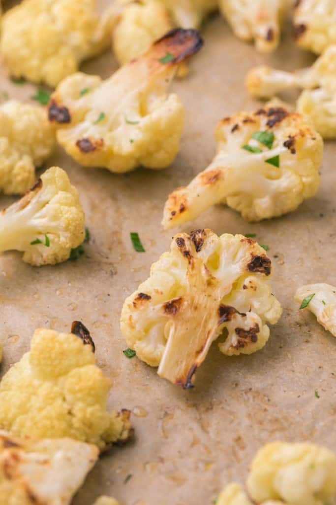 close up of a baking dish with seasoned roasted cauliflower