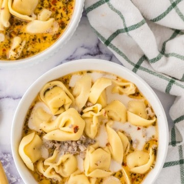 two portioned bowls of sausage tortellini soup