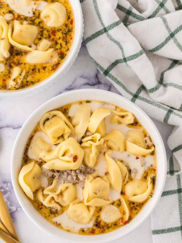 two portioned bowls of sausage tortellini soup