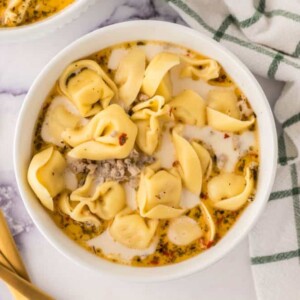 top view of two portioned bowls of sausage tortellini soup