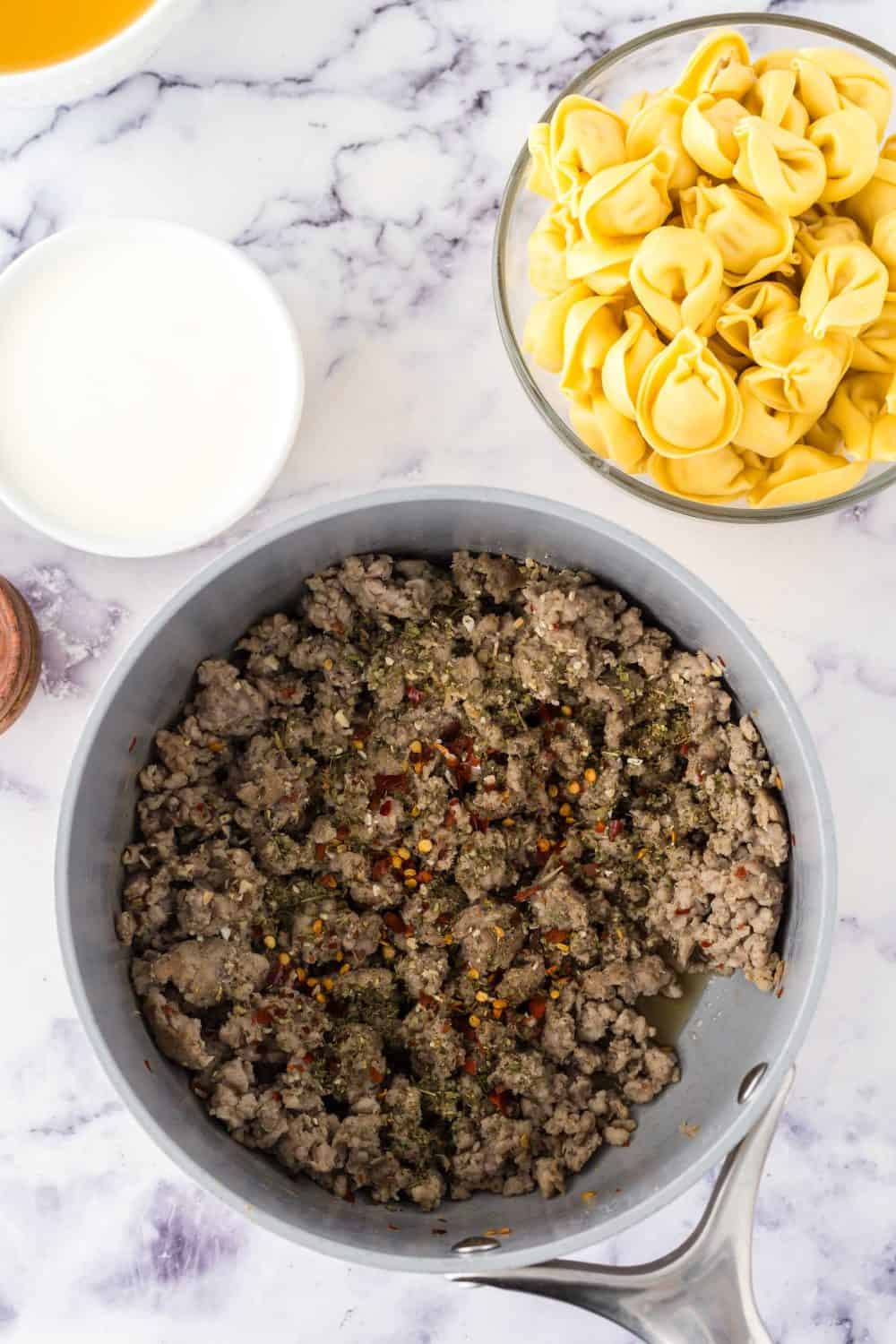 pot of ingredients for sausage tortellini soup