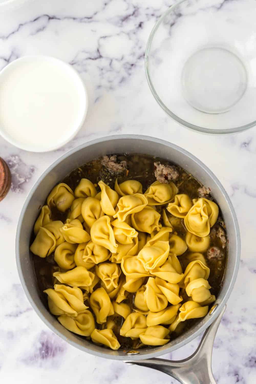 pot of ingredients for sausage tortellini soup