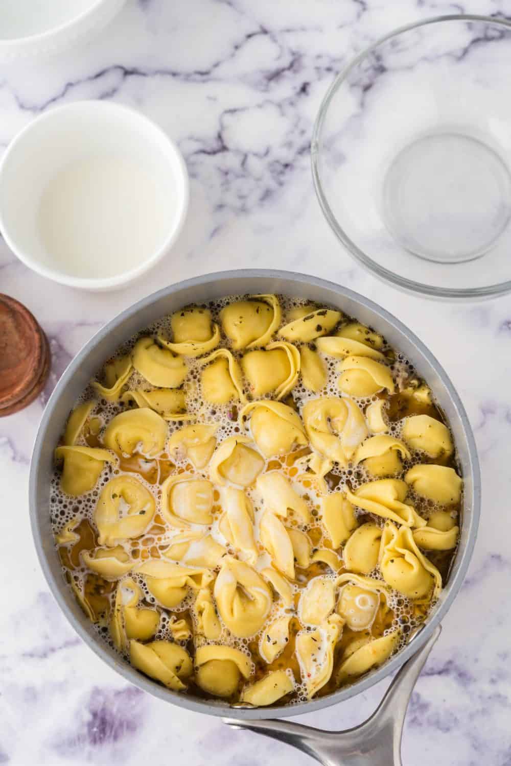 pot of ingredients for sausage tortellini soup